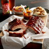 Bbq Baby Back Pork Ribs · Our original tender ribs, smoky mesquite BBQ sauce, flame-broiled. Served with choice of 2 s...