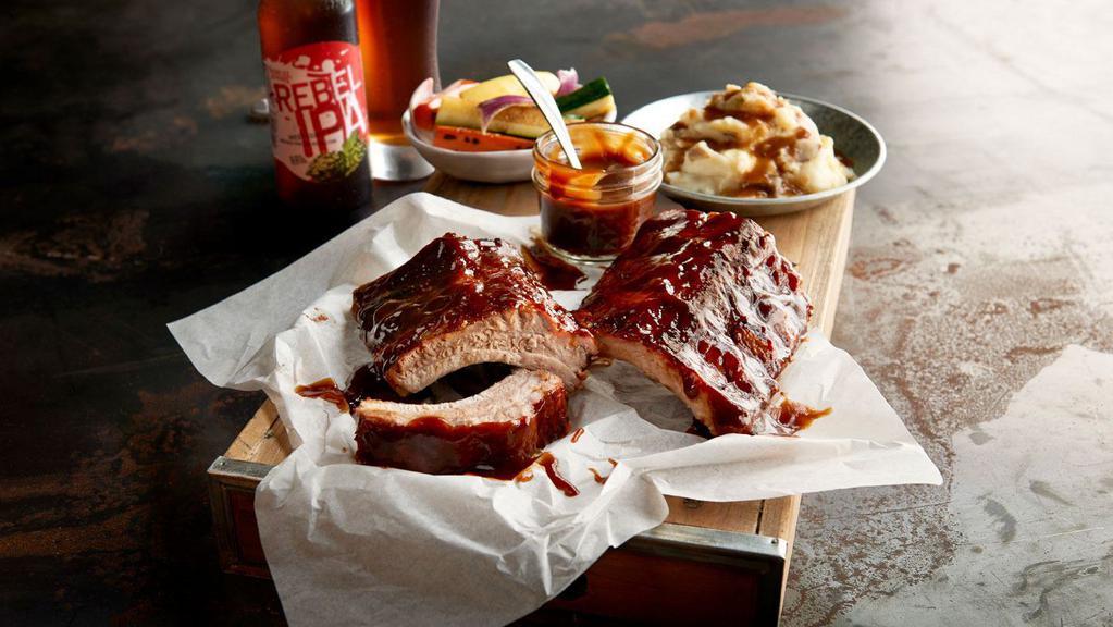 Bbq Baby Back Pork Ribs · Our original tender ribs, smoky mesquite BBQ sauce, flame-broiled. Served with choice of 2 sides.