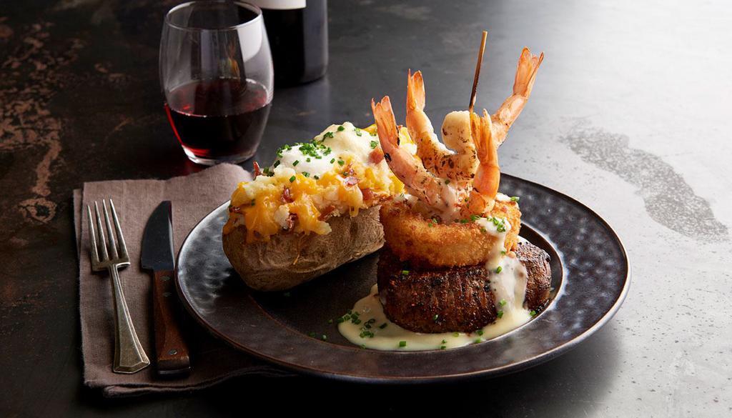 Steak & Shrimp · 7 oz Certified Angus Beef® Top Sirloin served with grilled shrimp, a Parmesan onion ring and lemon butter. Served with choice of 2 sides.