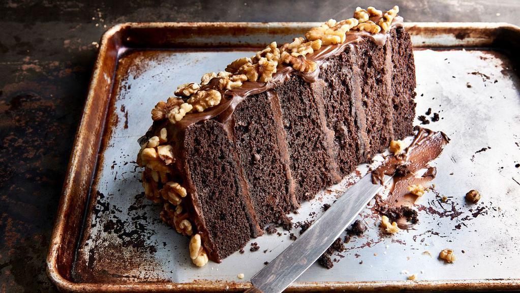 Chocolate Motherlode Cake · Six decadent layers of chocolate cake and rich fudge icing, topped with walnuts. Featured on the Food Network as one of America’s “Top 5 Most Decadent Desserts”