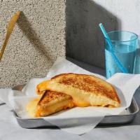 The Grown Up · Melted Cheddar, Swiss, and Jack cheeses grilled between two slices of buttered bread.