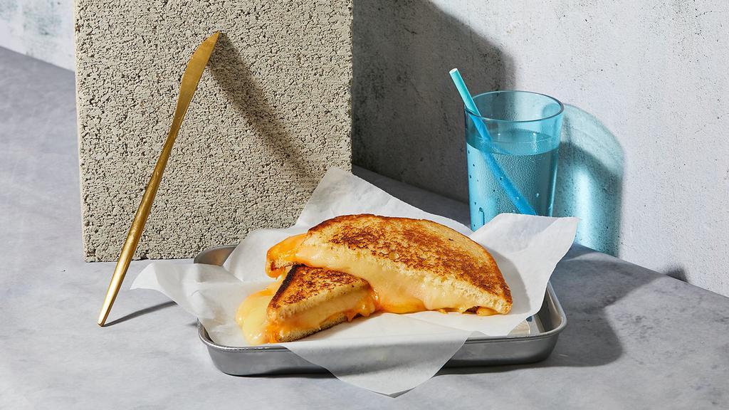The Grown Up · Melted Cheddar, Swiss, and Jack cheeses grilled between two slices of buttered bread.