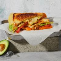 The Fancy · Melted Cheddar and Swiss with caramelized onions, tomato, avocado and mayonnaise grilled bet...