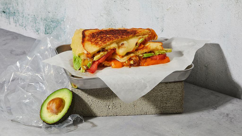 The Fancy · Melted Cheddar and Swiss with onions, tomato, avocado and mayonnaise grilled between two slices of buttered bread.