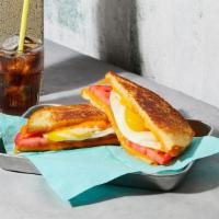 The Breakfast · Melted Cheddar cheese with a fried egg and tomato grilled between two slices of buttered bre...