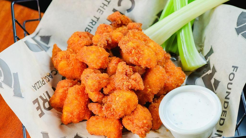 Boneless Wings,  1/2 Lb · Medallions of chicken tenders breaded in panko crumbs in your choice of mild, medium, hot, extra hot or garlic buffalo. Served with celery and your choice of dipping sauces: pesto ranch, ranch, blue cheese.
