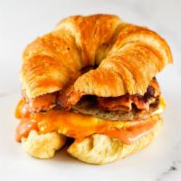 Croissant, Bacon, Sausage, Egg & Cheddar Sandwich · 2 scrambled eggs, melted Cheddar cheese, smoked bacon, breakfast sausage, and Sriracha aioli...