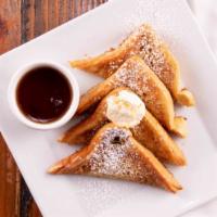 Berry Crunch French Toast · Strawberries and Blueberries over French toast topped with whipped cream and powdered sugar....