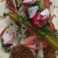 Falafel Wrap · Vegan, vegetarian. Fresh tomato, mint, radish, and parsley, with tahini sauce wrapped in a p...