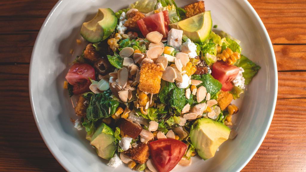 Chicken Avocado Salad · Romaine and red leaf lettuce, roasted corn, goat cheese, almonds, dates, tomatoes, avocado, corn bread croutons and champagne vinaigrette