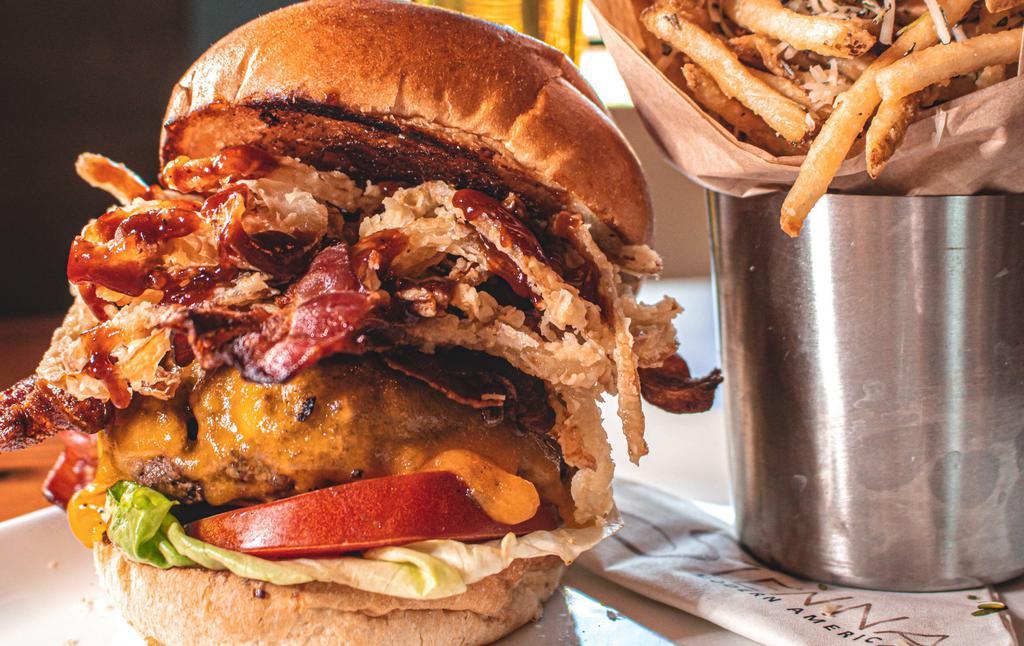 Bbq American Kobe Burger · Smokey bacon, crispy onion strings and tangy BBQ sauce with rosemary parmesan frites or side salad