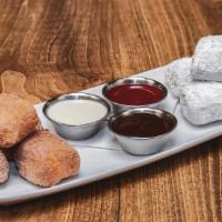 Sienna Doughnut Holes · Jack Daniels Creme Anglaise, Raspberry Sauce and Creamy Dark Chocolate dipping sauces