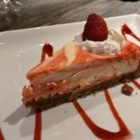 Raspberry Swirl Cheesecake · New York style cheesecake with raspberry swirl and whipped cream