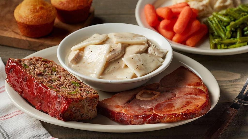 Cracker Barrel Sampler · A hearty portion of our Chicken n' Dumplins, Meatloaf and Sugar Cured or Country Ham. Served with your choice of three Country Sides and Buttermilk Biscuits (160 cal each) or Corn Muffins (210 cal each)..