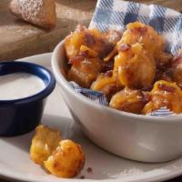 Loaded Hashbrown Casserole Tots · Our Hashbrown Casserole fried into crispy bite-sized tator tots loaded with bacon pieces and...