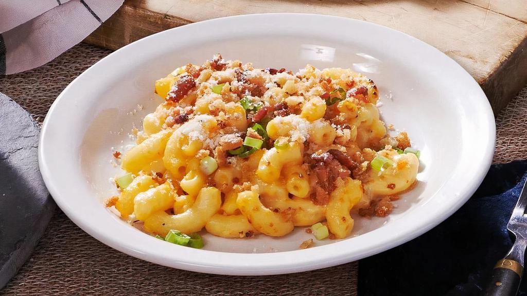 Bacon Mac N’ Cheese · There's a new way to enjoy a classic. Our creamy mac n' cheese comes topped with crispy bacon bites, parsley, green onions, and parmesan cheese. .