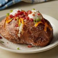 Loaded Baked Potato · Baked Potato topped with shredded Colby Cheese, bacon pieces, whipped butter, Sour Cream and...