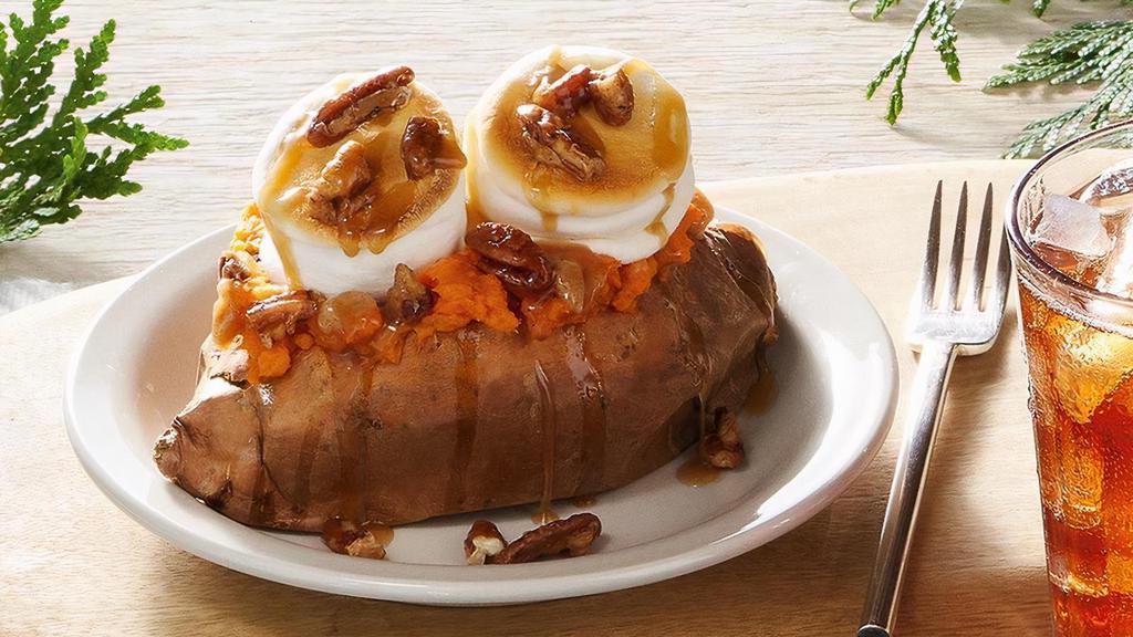 Loaded Baked Sweet Potato · Baked Sweet Potato topped with Brown Sugar Cinnamon Butter, toasted Marshmallows, Butter Pecan Syrup and Candied Pecans. *Contains Pecans..