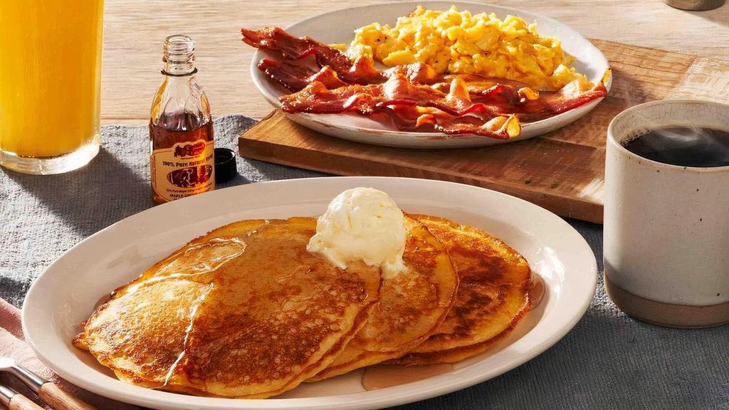 Momma'S Pancake Breakfast® · Three Buttermilk Pancakes topped with butter and served with two eggs. Plus Thick-Sliced Bacon or sausage and 100% Pure Natural Syrup.