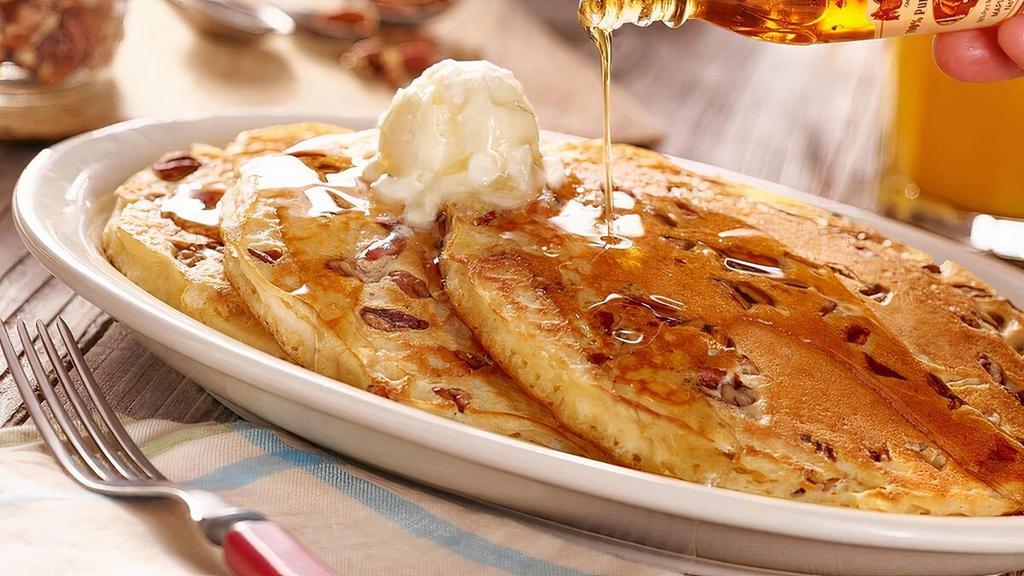Pecan Pancakes · Three Buttermilk Pancakes n’ butter filled with pecans. Plus 100% Pure Natural Syrup..