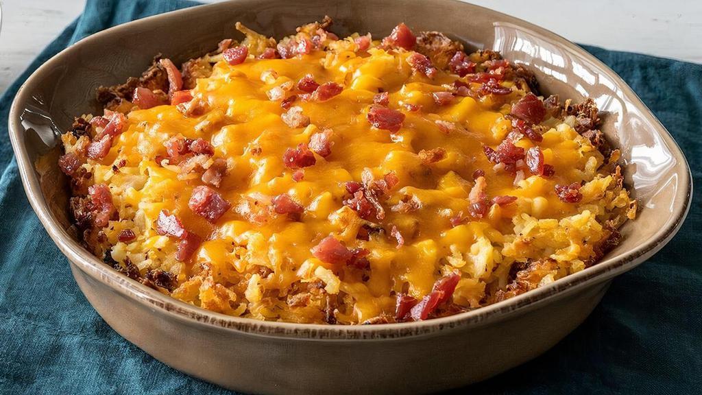 Loaded Hashbrown Casserole · Our Hashbrown Casserole grilled and topped with Colby Cheese, and bacon pieces. Packed hot and ready to serve..