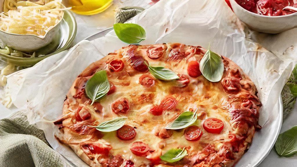Margherita Pizza  · Mozzarella di bufala, tomatoes, basil, olive oil.