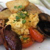 Huevos Con Chorizo Breakfast · Scrambled eggs with chopped onion and chorizo. Served with rice and beans, sour cream and gu...