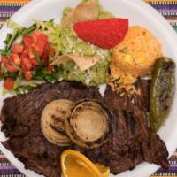 Carne Asada Plate · Marinated ranchera steak, Served with sauteed vegetables, garlic & olive oil, house salad, a...