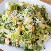 Caesar Salad · Romaine, Parmesan Flakes, Fresh Baked Croutons, & Caesar Dressing.