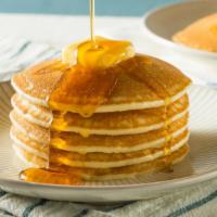 3 Fluffy Hotcakes · Fresh fluffy pancakes topped with a side of syrup and butter.