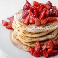 3 Fluffy Strawberry Hotcakes · Fresh fluffy pancakes topped with strawberrys with a side of syrup and butter.