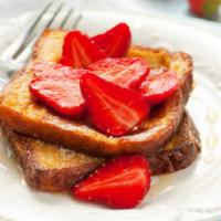 Strawberry French Toast · Fresh homemade French toast made from thick brioche bread topped with strawberries.