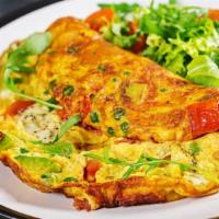 Healthy Omelette · Creamy avocado, tomato, onion, zucchini, bell pepper and melted cheese folded into fresh eggs.