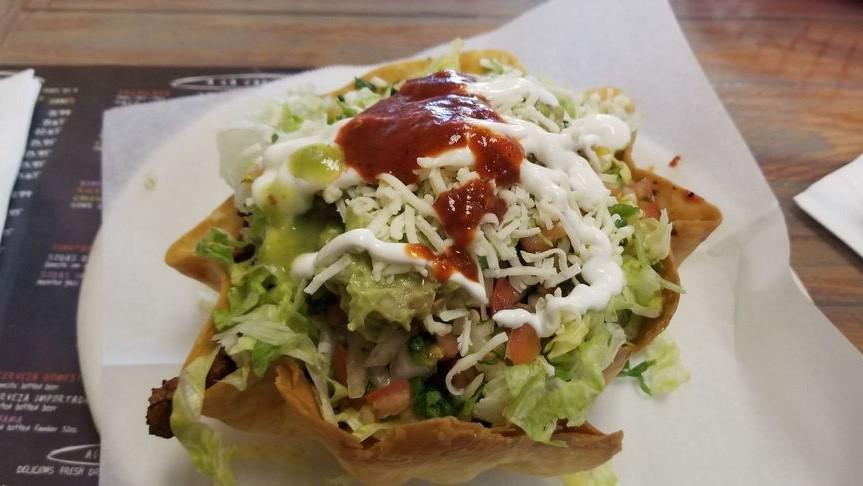 Taco Salad · Choice of meat, rice, beans, lettuce, cheese, sour cream, guacamole & salsa.