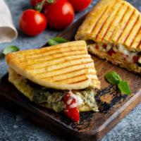 Grilled Chicken Pesto Panini · Hearty grilled chicken, house made pesto, swiss cheese, avocado, tomato, and caramelized oni...
