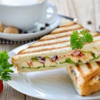 Roasted Turkey Breast Panini · Flavorful turkey breast, avocado, Swiss cheese, tomato, grilled onions, honey mustard, and m...