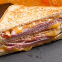 Ham And Cheese Panini · Juicy ham, sliced cheese, avocado, honey mustard, and mayo, served with a choice of side.