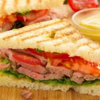 Roast Beef Panini · Juicy roast beef, Swiss cheese, tomato, cilantro, and chipotle sauce, served with a choice o...