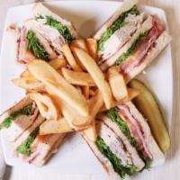 Club Sandwich · Roasted turkey, ham, crispy bacon, lettuce, tomatoes and mayo on white toast. .