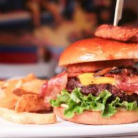Cowboy Burger · IT's HUGE! Our Angus burger smothered with sauteed mushrooms, onion rings, bacon and America...