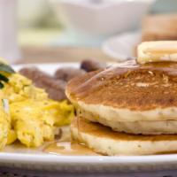 Original Buttermilk Pancakes & Eggs · Three fluffy buttermilk pancakes topped with whipped cream and fresh cage-free eggs. Maple s...