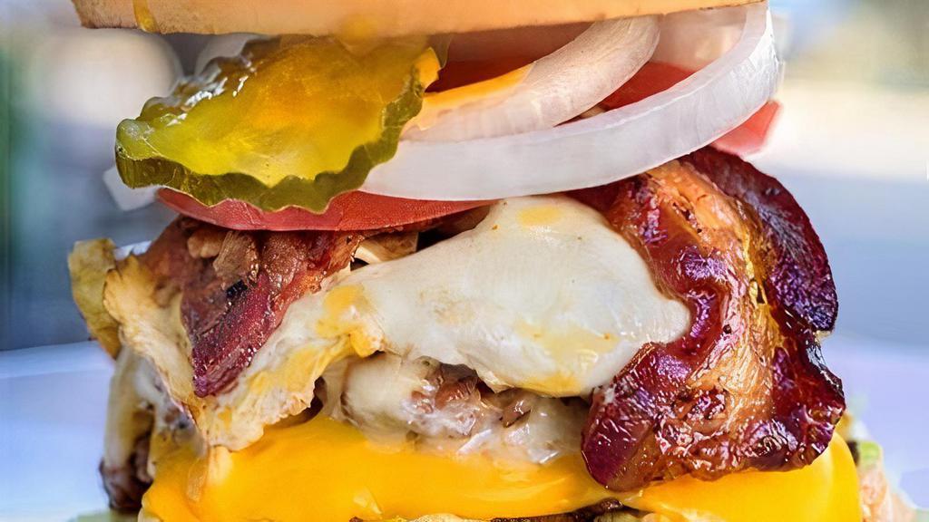 Badmash Burger · Lettuce, badmash sauce, double patty, egg, bacon, swiss cheddar cheese,  mayo, pickles, onions, tomatoes.