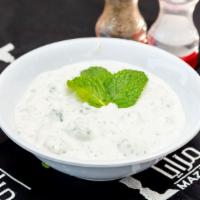 Cucumber Yogurt · Cucumber yogurt dip, garlic and topped with dry mint.
