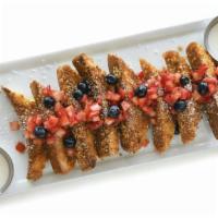 Crunchy French Toast · French brioche dipped in our secret batter, rolled in crunchy corn flakes and grilled to per...