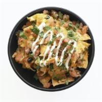 Chilaquiles · Corn Tortilla
chips, Sunny-Side Up Eggs,
Braised Pulled Chicken
(Tinga), Black Beans, Cotija...