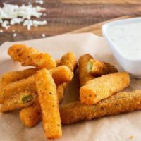Zucchini Sticks (10 Pcs) · Sliced zucchini strips, breaded, seasoned, and fried. Served with a side of dressing.