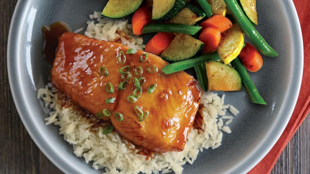 Honey Ginger Glazed Salmon · Grilled salmon fillet brushed with a house-made honey ginger glaze, served atop rice with seasonal vegetables. Cal 570.