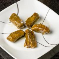 Dolmeh · Rice and herbs wrapped in cooked grape leaves.