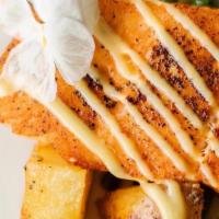 Roasted Salmon · sautéed potatoes and baby vegetables (chef's choice) in creamy lemon sauce.