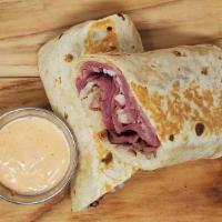 The Blackstone Wrap · flour tortilla rolled up + stuffed with corned beef, smoked swiss, caramelized onions, sauer...